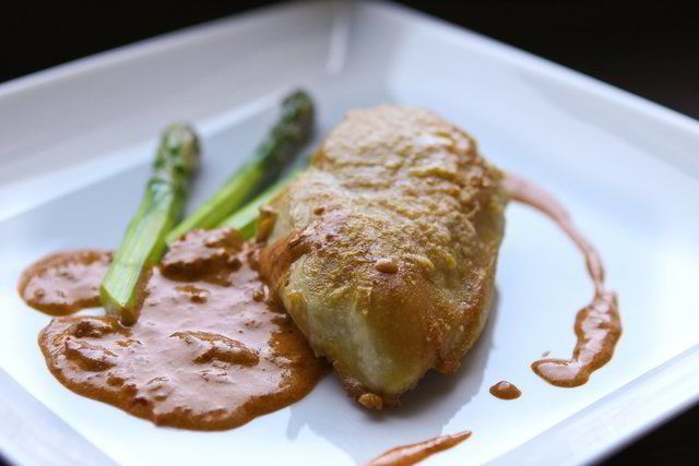 A plated chicken entree with asparagus from the 360 kitchen