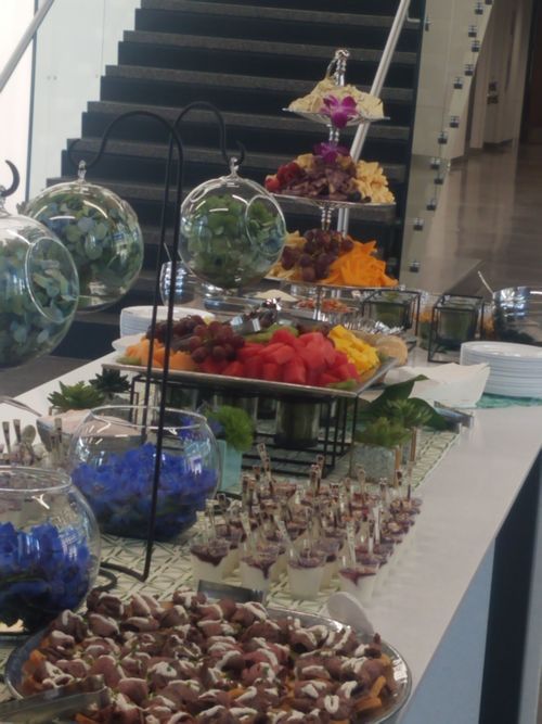 A 360 Catering display table with fruit, appetizers and desserts at an event
